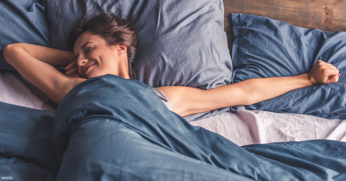 Brunette woman sleeping in bed (model)