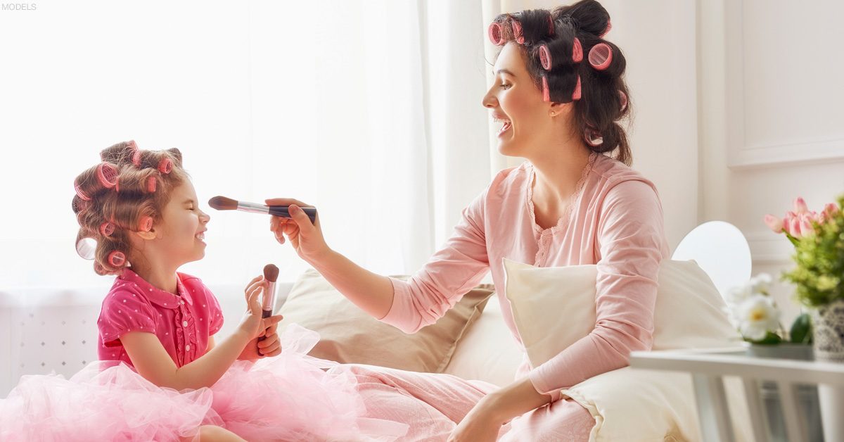 Mother playing with daughter after mommy makeover