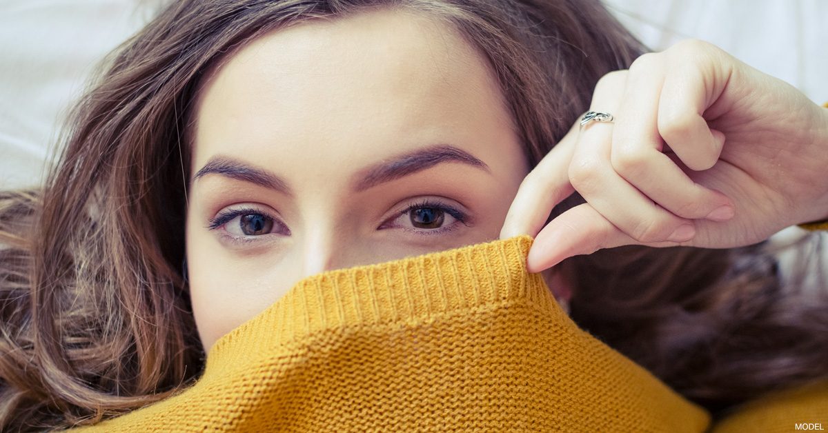 Woman hiding acne scars.