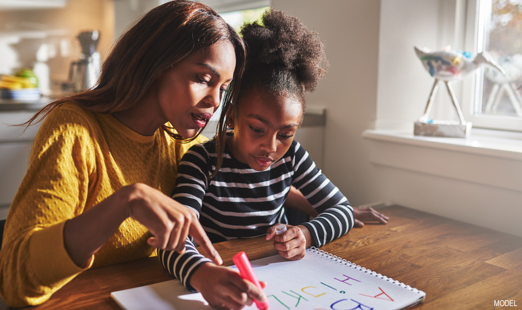 Mother helping child with homework