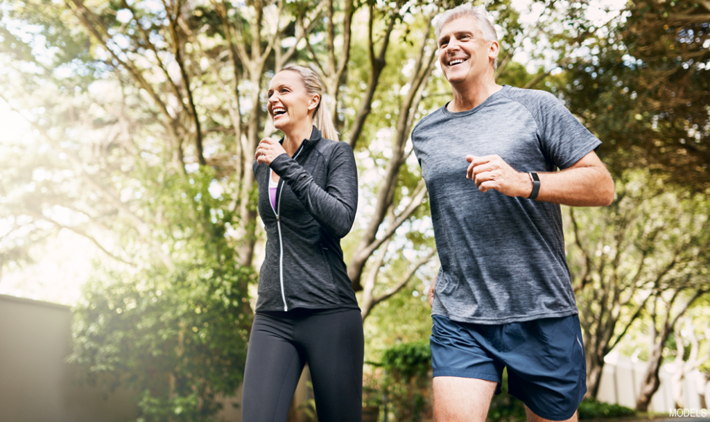 Confident, thin woman exercising with her husband after liposuction