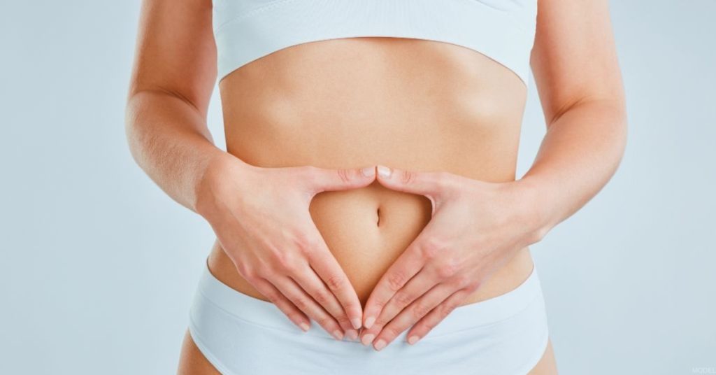 Woman with hands on her stomach (MODEL)