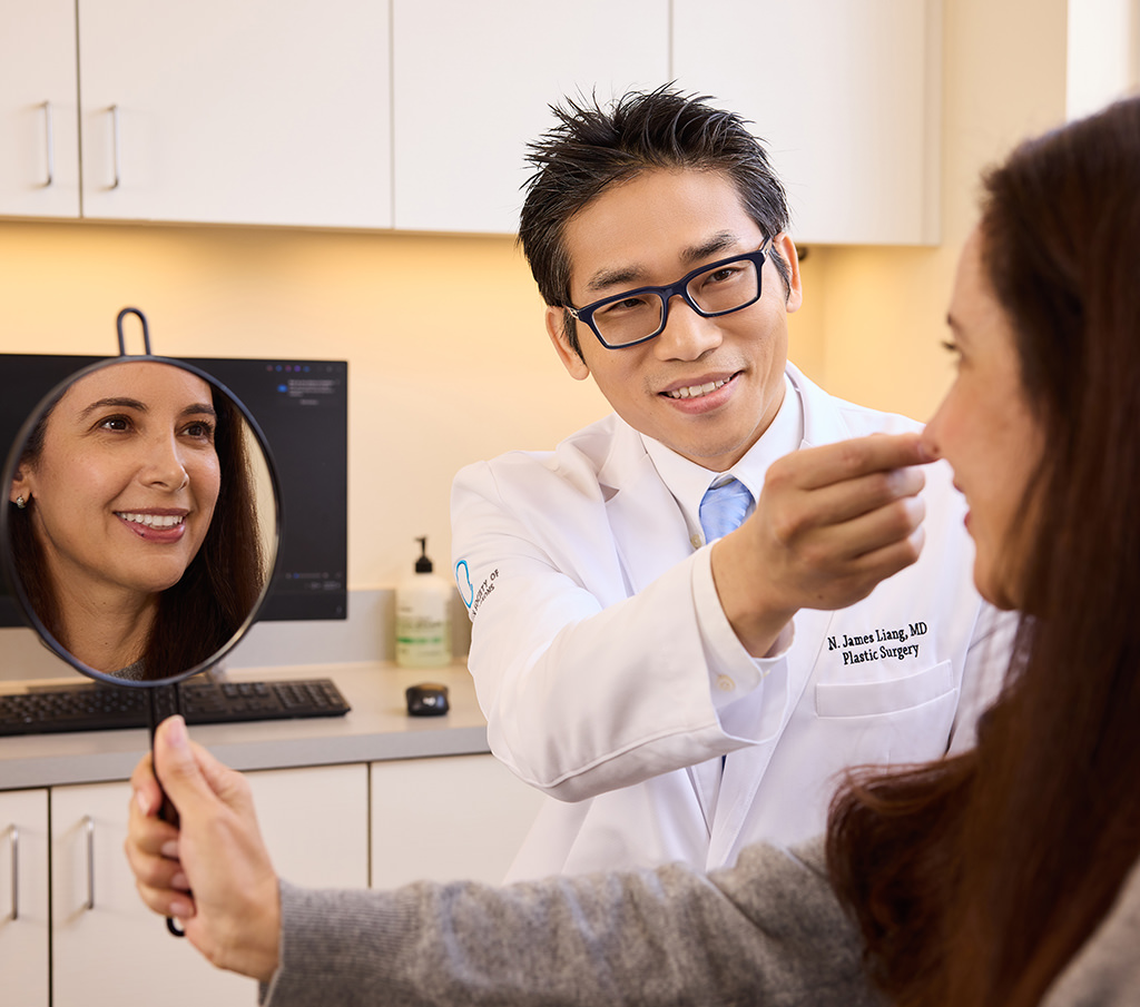 Dr. Ni-Jui James Liang examining a patient’s face during a plastic surgery consultation